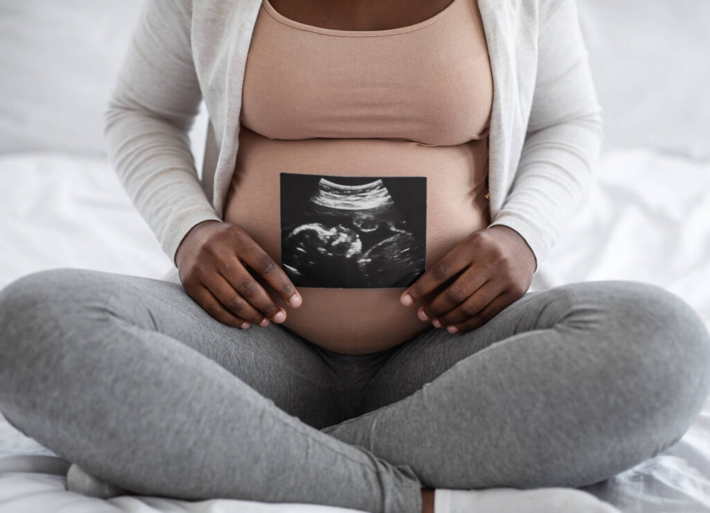 Pregnant woman with ultrasound photo.jpg